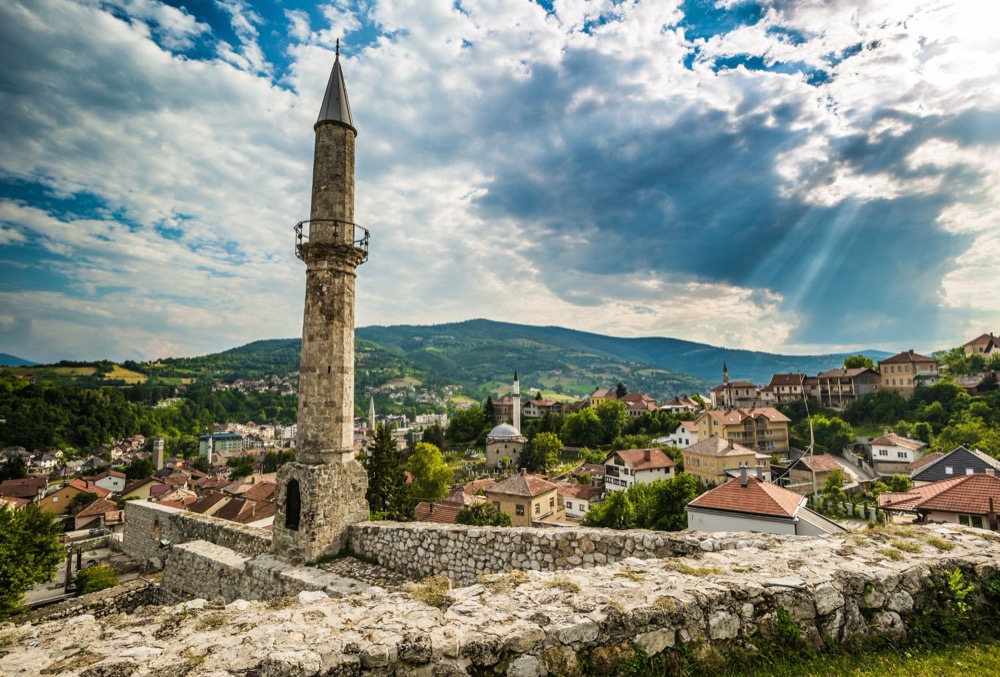 Travnik rooftops, minarets and surrounding green hills